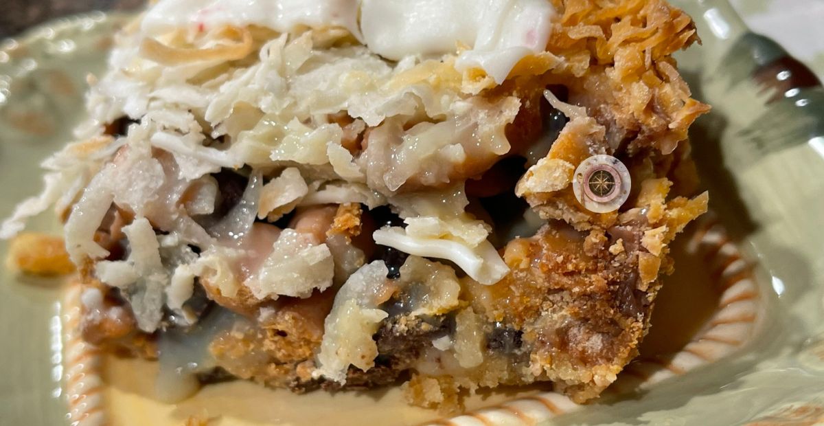 the butterscotch coconut bar sits on a plate freshly out of the oven